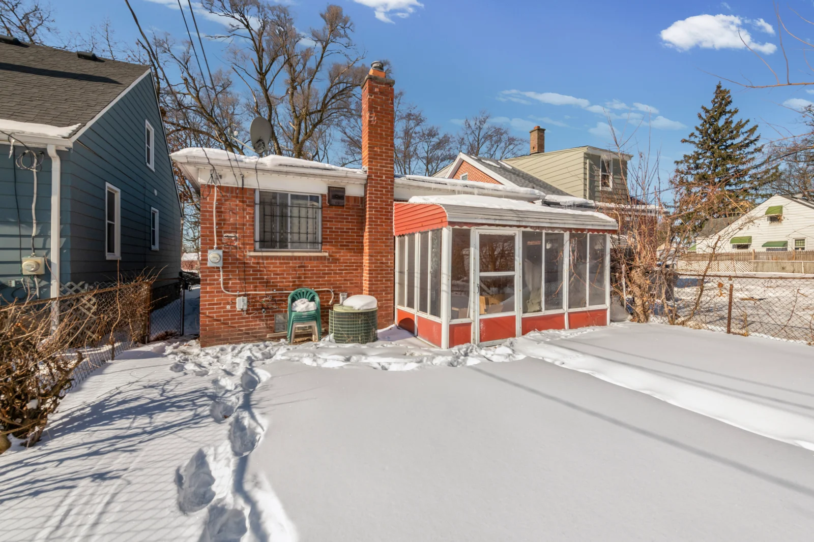 19614 St. Aubin — rear exterior and enclosed porch, February 2026