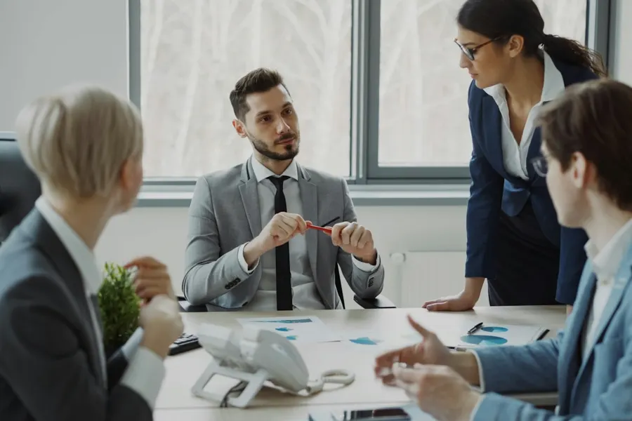 Professionals in a meeting around a conference table