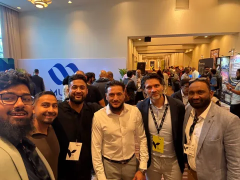 A group photo of about a dozen people at an event.
