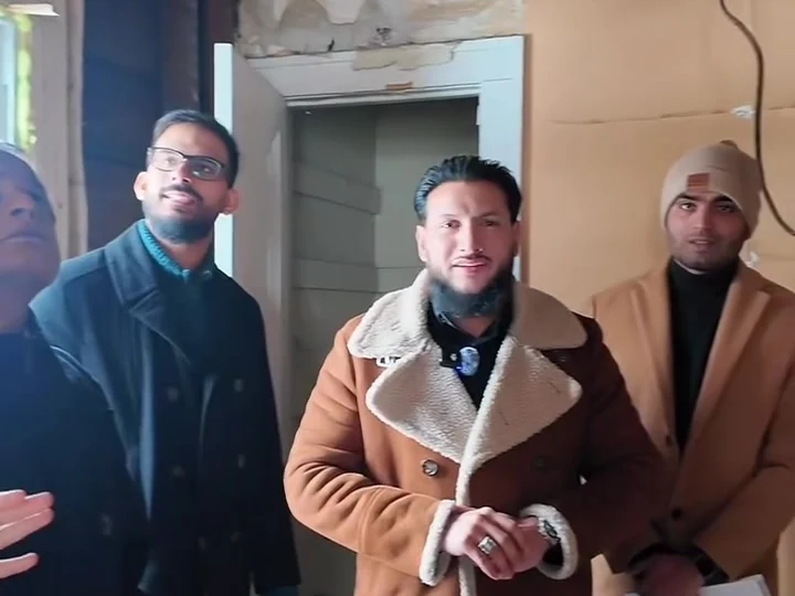A group talking together inside a property during a tour.