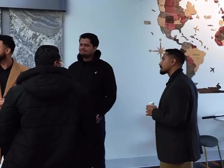 People talking together indoors before the property tour.